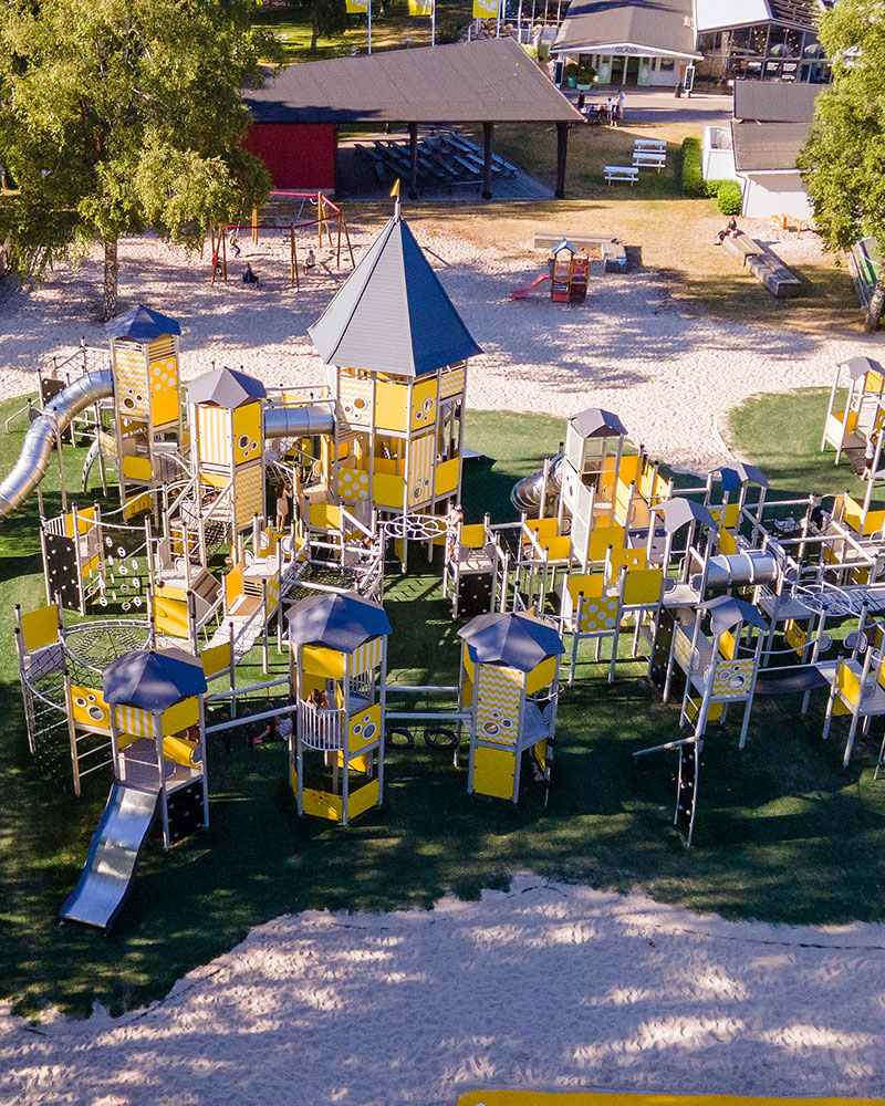 Ariel view of a large yellow playground unit, it spans a huge space and is one of Sweden's largest continuous playground units.